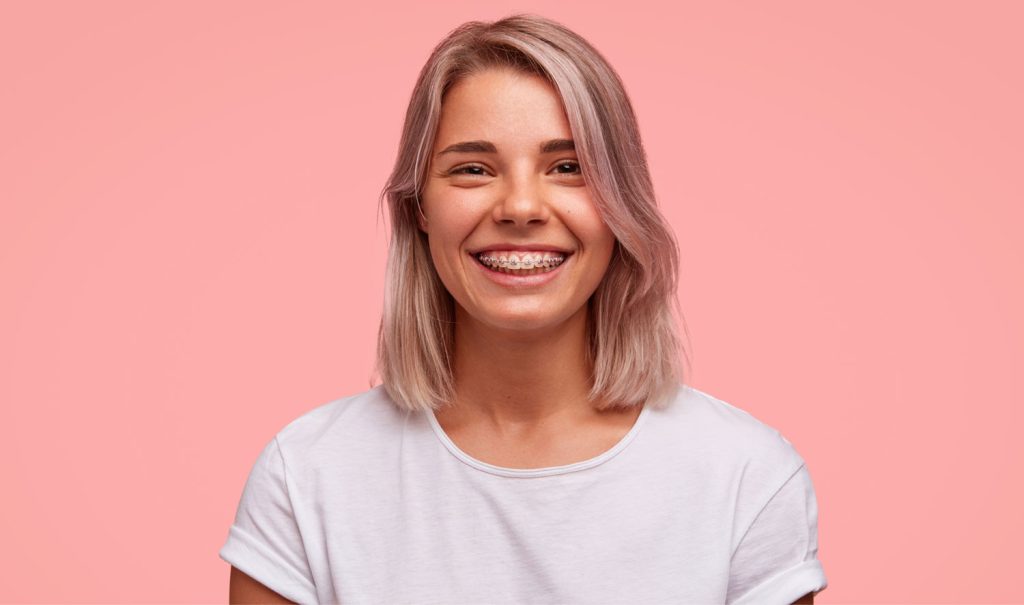 Young Woman Smiling With Braces On Her Teeth