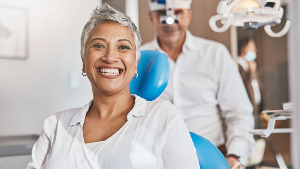 Woman Smiling In Dentist Office