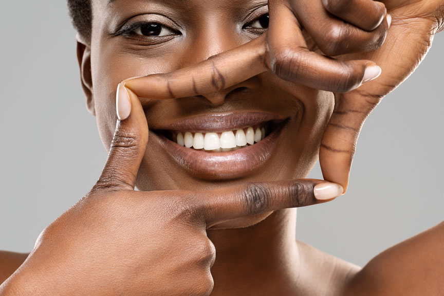 Woman Framing Her Bright Smile with Fingers