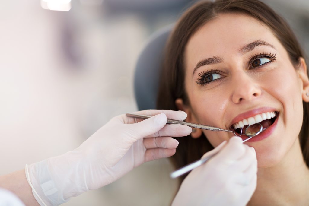Woman Smiling During Dental Examination
