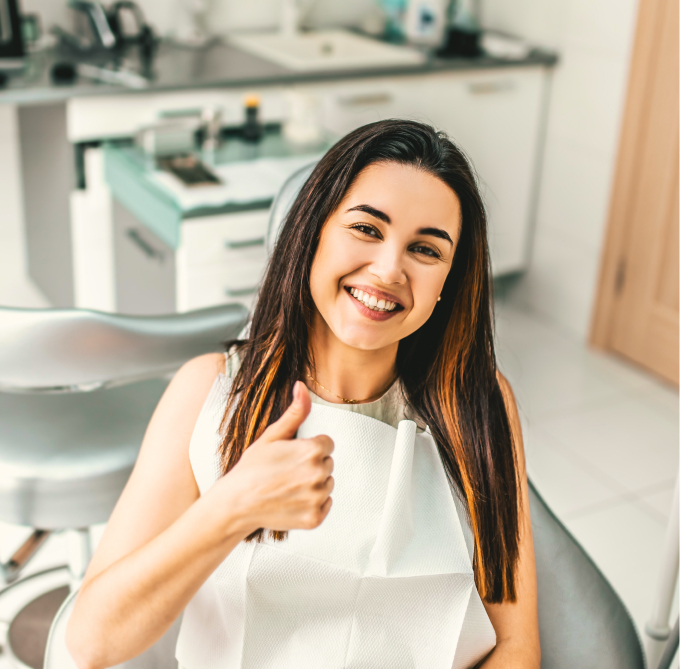 Woman Smiling and Giving a Thumbs-Up