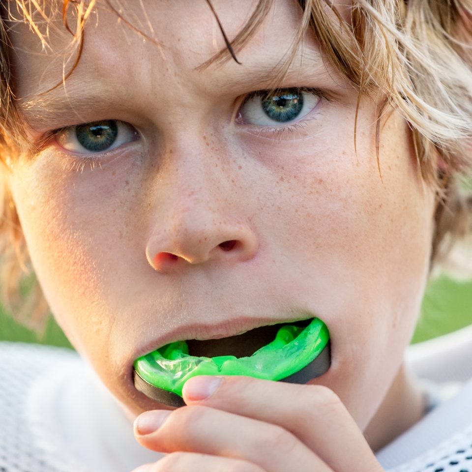 Boy putting in his mouth guard
