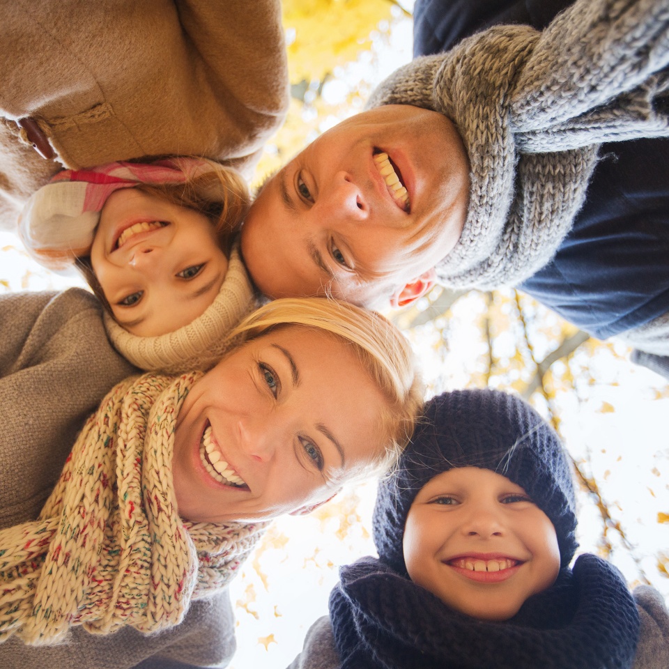 family, childhood, season and people concept - happy family in autumn park
