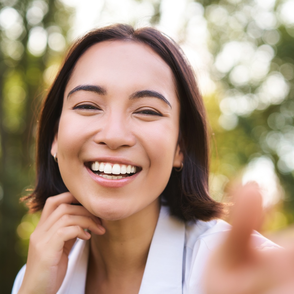 Genuine people. Portrait of asian woman laughing and smiling, walking in park, feeling joy and positivity.