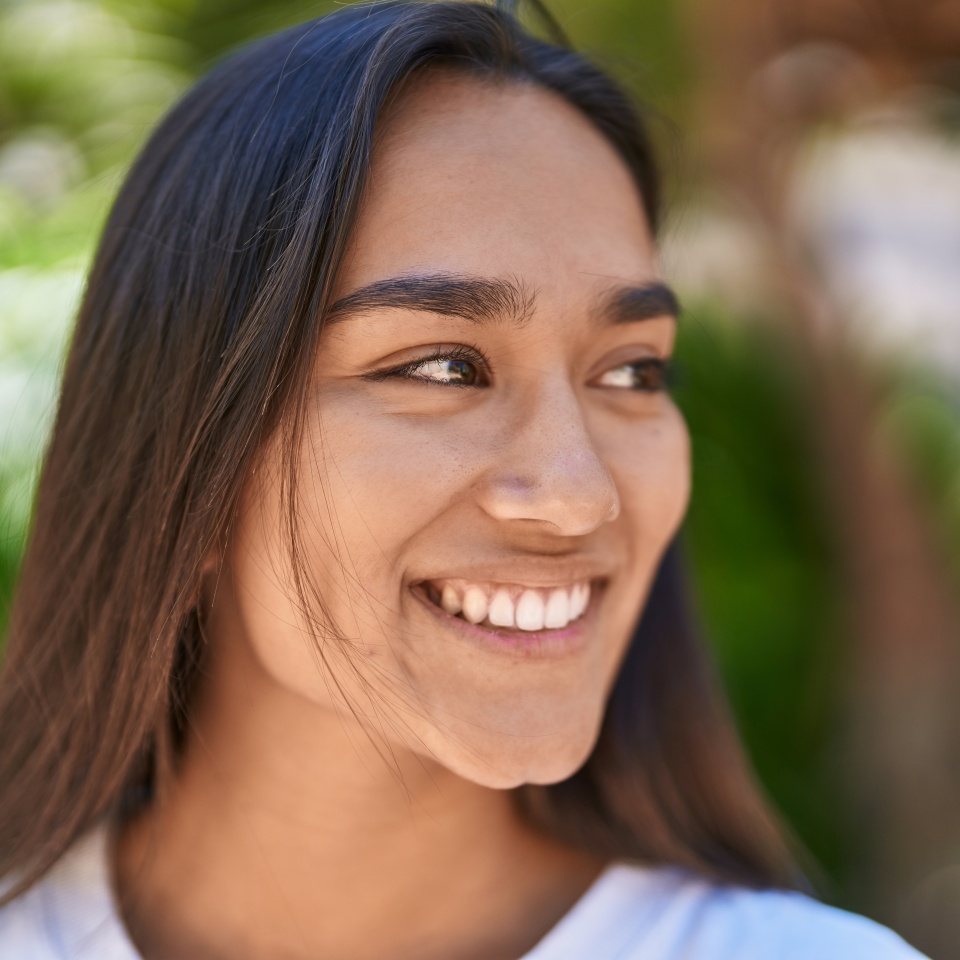 Young beautiful hispanic woman smiling confident looking to the side at park