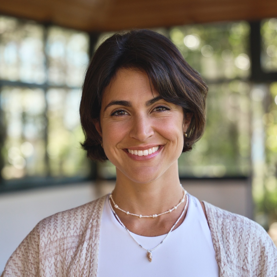 Young happy smiling confident Hispanic woman yoga coach instructor, holistic teacher looking at camera standing in yoga studio advertising retreat mind body health therapy. Close up portrait.