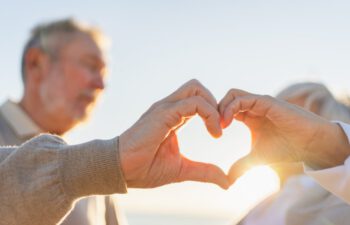Love heart shape peace. Senior older couple making heart shape with their hands. Adult mature old husband wife showing heart sign. Happy pensioner family. I love you happy valentines day