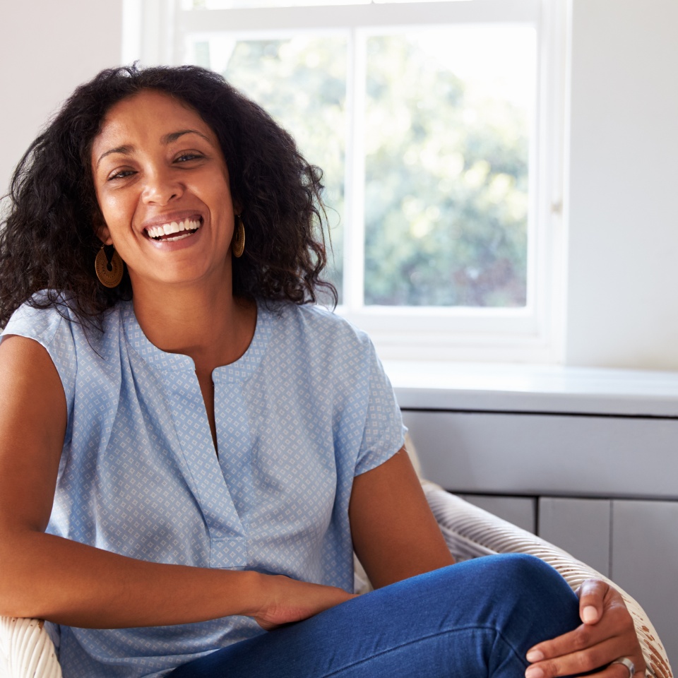 Portrait Of Woman Sitting In Chair At Home