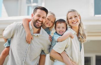 Parents, piggyback and children outdoor in portrait for love, bonding and playful interaction of support at house. Smile, woman and man with kids for family activity in backyard for memory at home